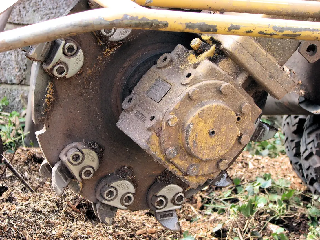 Close view of a stump grinder cutting wheel and teeth